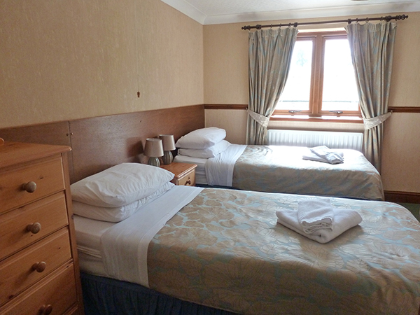 Bedroom 3 at Ashwood Lodge is a warm, cosy twin room with ample storage for clothes, bags and other personal items.