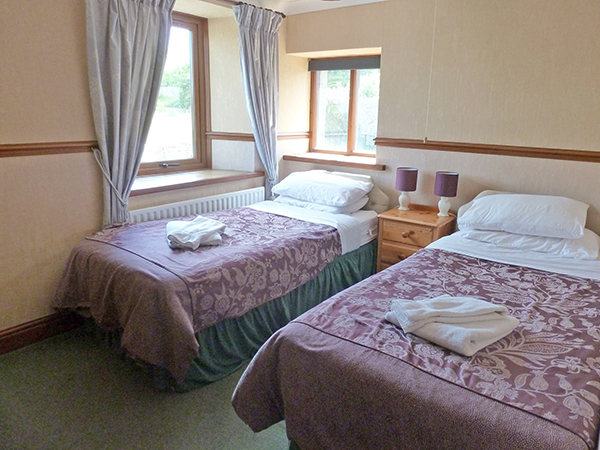 Ashwood Lodge's Bedroom 6 is a bright twin room, adjacent to the shared bathroom.