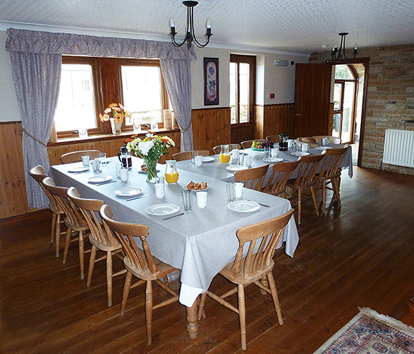 The large dining room in Ashwood Lodge is at the heart of the building. With seating at the tables for up to 17 guests. It is equipped with a selection of board games, books and other rainy-day activities.