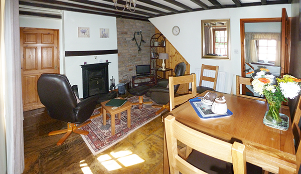 Bide-A-Wee cottage's cosy dining room, complete with traditional open fire
